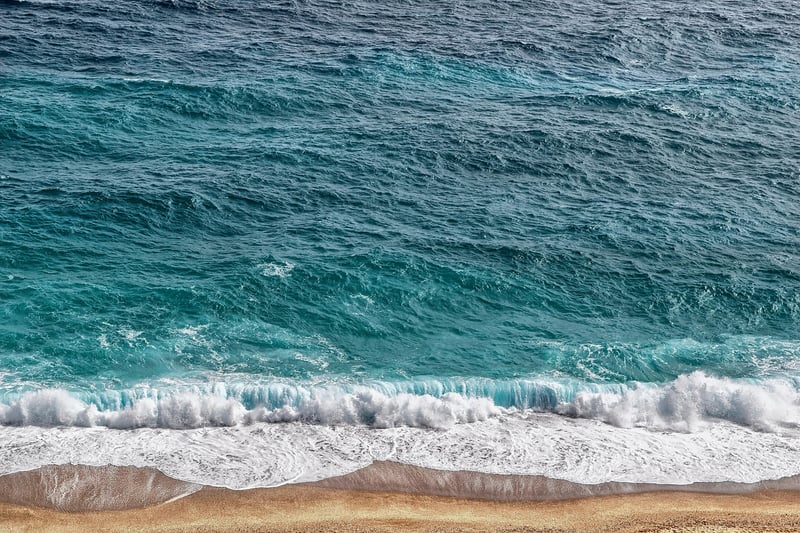Beach with sand and ocean waves